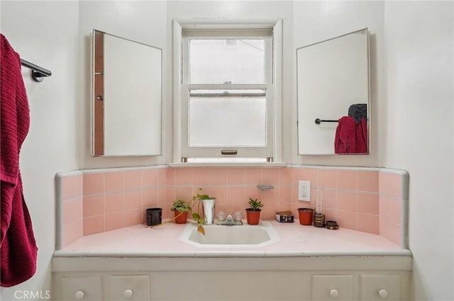 bathroom with vanity and decorative backsplash