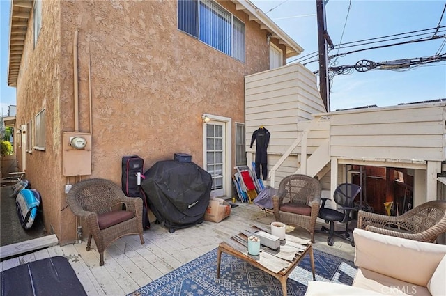 view of patio / terrace featuring grilling area, a wooden deck, and an outdoor hangout area