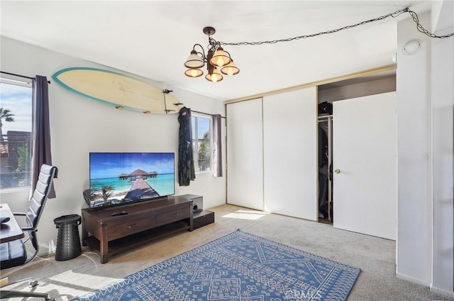 living area featuring carpet floors and an inviting chandelier