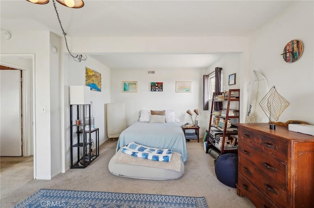 bedroom with carpet floors, baseboards, and visible vents