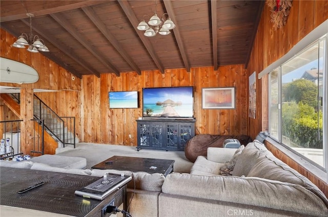 living area with carpet floors, wood walls, lofted ceiling with beams, and wood ceiling