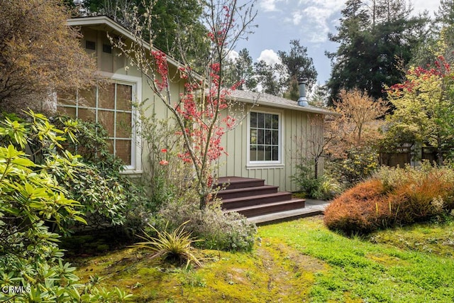 rear view of property with board and batten siding
