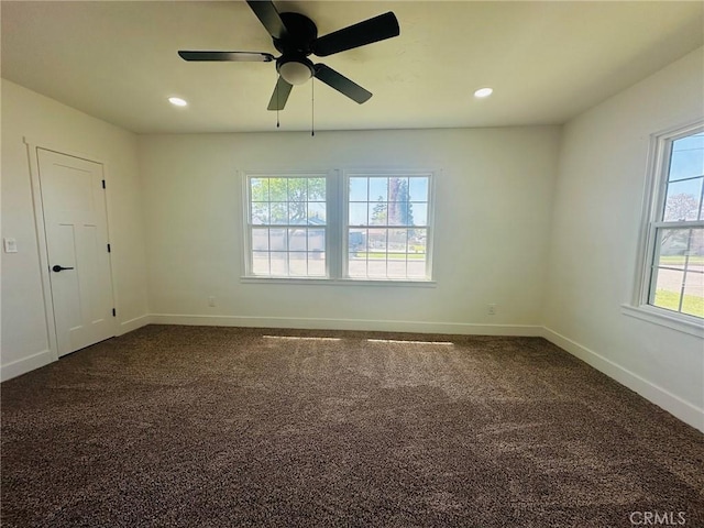 spare room featuring dark colored carpet, a ceiling fan, baseboards, and recessed lighting
