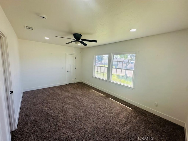 empty room with visible vents, baseboards, recessed lighting, and dark colored carpet