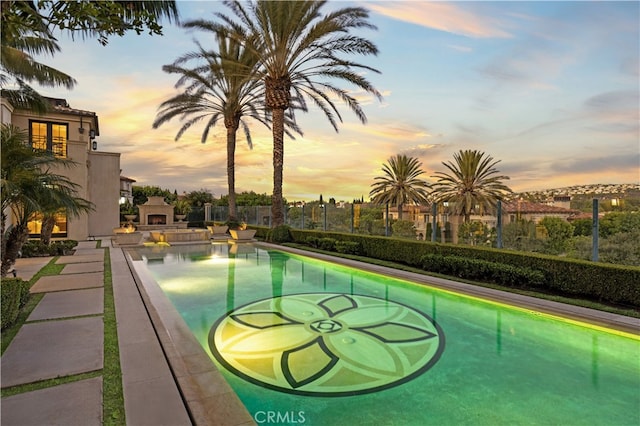 9 Shoreridge, Newport Coast, CA 92657 - view of swimming pool featuring a warm lit fireplace