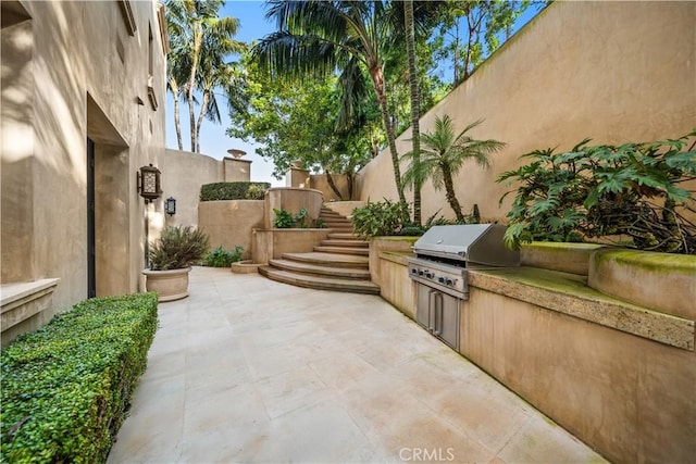 9 Shoreridge, Newport Coast, CA 92657 - view of patio featuring a grill, an outdoor kitchen, fence, and stairs