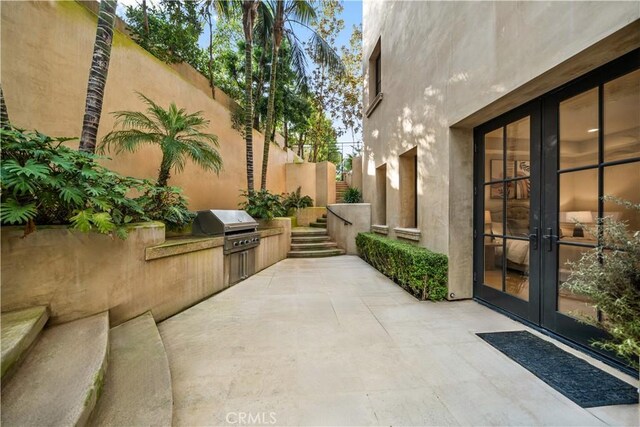 9 Shoreridge, Newport Coast, CA 92657 - view of patio with grilling area, french doors, fence, and an outdoor kitchen