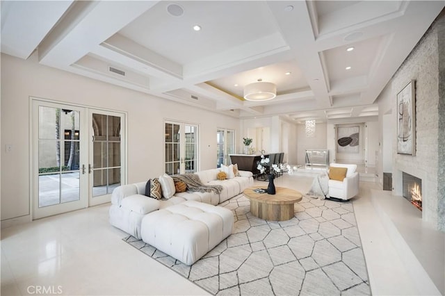 9 Shoreridge, Newport Coast, CA 92657 - living area featuring french doors, a stone fireplace, beam ceiling, and coffered ceiling