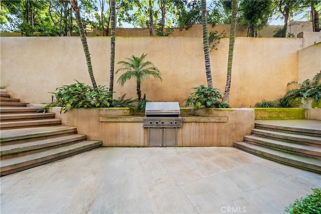 9 Shoreridge, Newport Coast, CA 92657 - view of patio / terrace featuring area for grilling, stairs, fence, and exterior kitchen