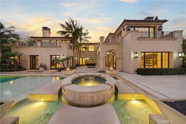 9 Shoreridge, Newport Coast, CA 92657 - exterior space featuring a pool with connected hot tub, a patio, a balcony, french doors, and stucco siding