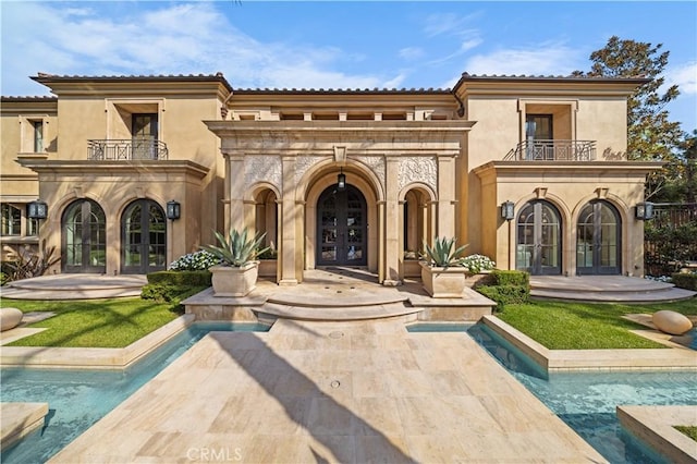 9 Shoreridge, Newport Coast, CA 92657 - back of house with french doors, stucco siding, and a balcony