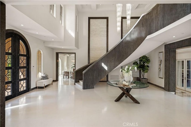 9 Shoreridge, Newport Coast, CA 92657 - foyer entrance featuring baseboards, arched walkways, a high ceiling, stairs, and french doors