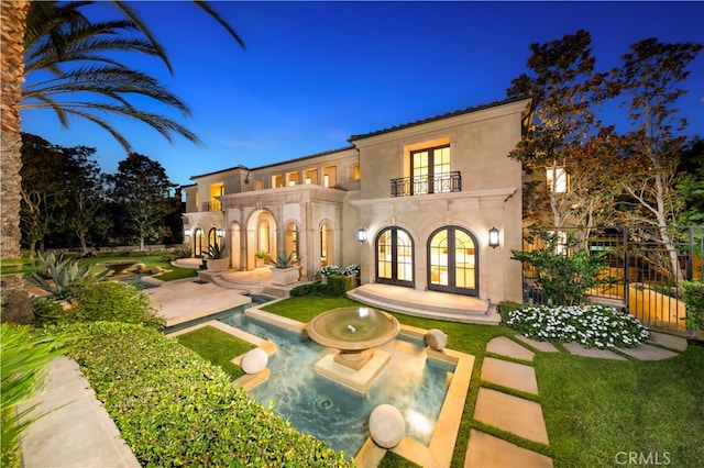 9 Shoreridge, Newport Coast, CA 92657 - back of house featuring a balcony, stucco siding, french doors, a patio area, and fence