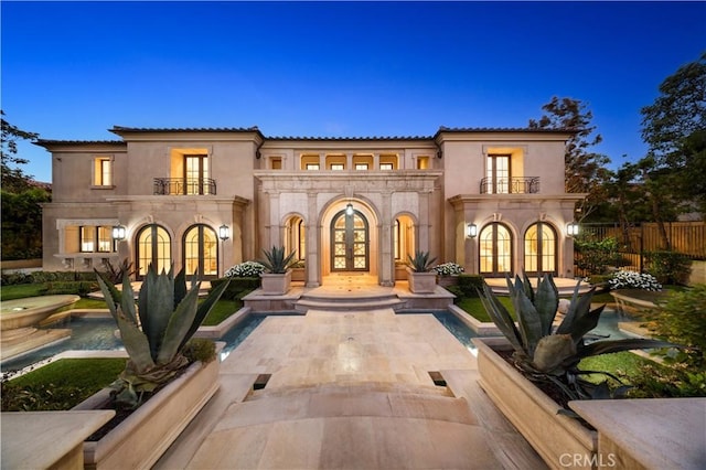 9 Shoreridge, Newport Coast, CA 92657 - view of front of home with a balcony, french doors, fence, and stucco siding