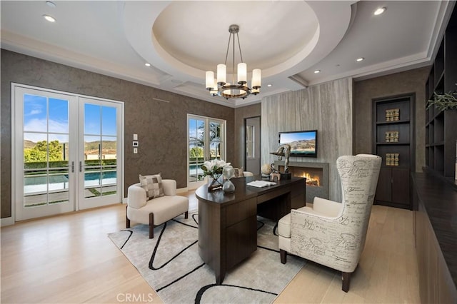 9 Shoreridge, Newport Coast, CA 92657 - office space featuring built in shelves, a chandelier, a fireplace, light wood finished floors, and recessed lighting