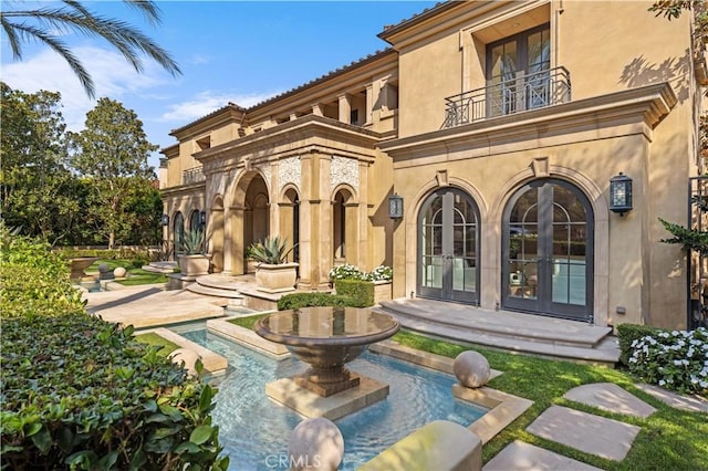 9 Shoreridge, Newport Coast, CA 92657 - back of property featuring french doors, a patio area, stucco siding, and a balcony