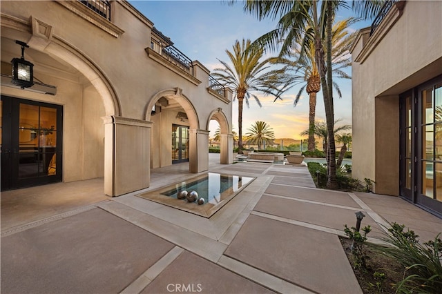 9 Shoreridge, Newport Coast, CA 92657 - patio terrace at dusk featuring a balcony, french doors, and an outdoor hot tub