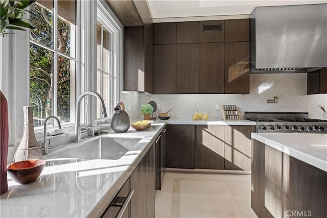 9 Shoreridge, Newport Coast, CA 92657 - kitchen with wall chimney range hood, dark brown cabinetry, modern cabinets, and a sink