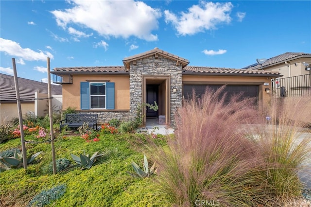 1373 Topanga Dr, San Marcos, CA 92069 - mediterranean / spanish-style home featuring stone siding, stucco siding, a tile roof, and a garage
