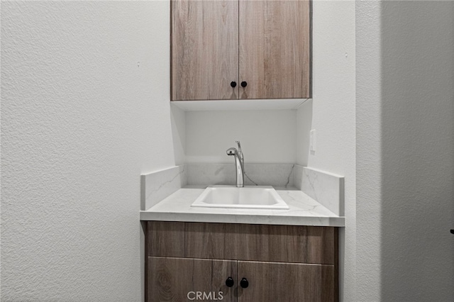 1373 Topanga Dr, San Marcos, CA 92069 - laundry room featuring a textured wall and a sink