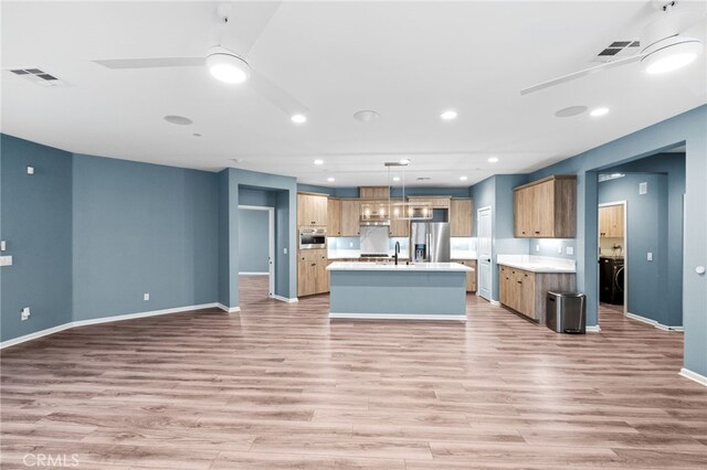 1373 Topanga Dr, San Marcos, CA 92069 - kitchen with stainless steel appliances, light countertops, light wood-type flooring, open floor plan, and ceiling fan