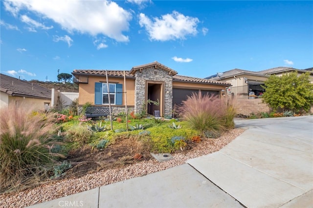 1373 Topanga Dr, San Marcos, CA 92069 - view of front of home featuring stone siding, a garage, a tiled roof, stucco siding, and concrete driveway