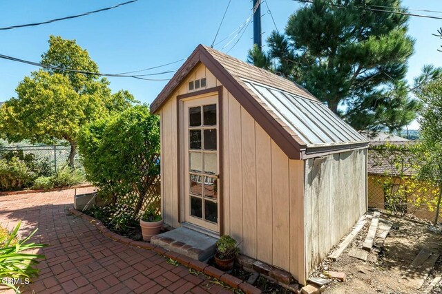 view of shed featuring fence