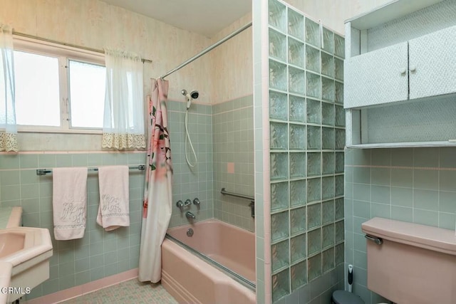 bathroom featuring shower / bath combo, tile patterned flooring, and tile walls