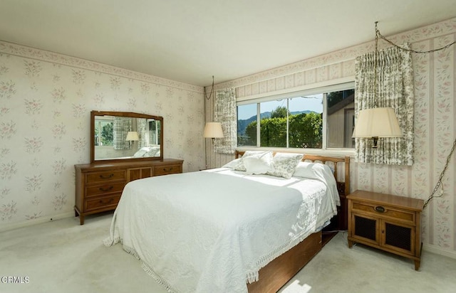 bedroom with wallpapered walls, baseboards, and carpet floors