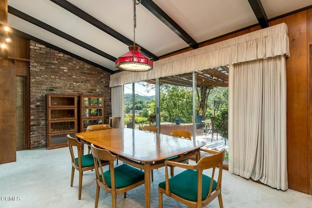 dining space with light carpet and lofted ceiling with beams
