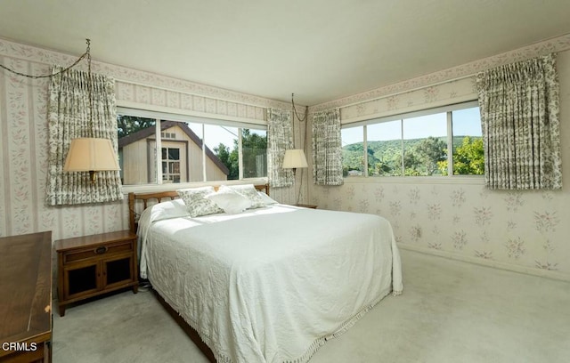 bedroom with carpet and wallpapered walls