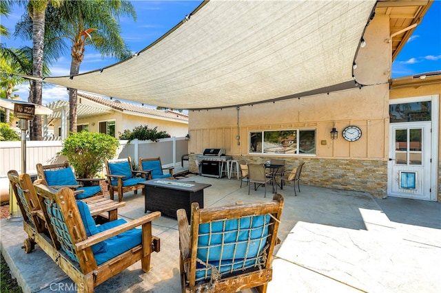 view of patio / terrace with fence, grilling area, outdoor dining space, and an outdoor living space with a fire pit