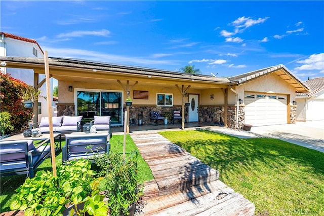 back of property featuring stucco siding, outdoor lounge area, stone siding, a garage, and driveway
