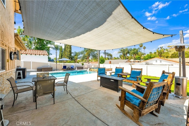view of patio featuring a fenced backyard, an outdoor living space with a fire pit, and outdoor dining area