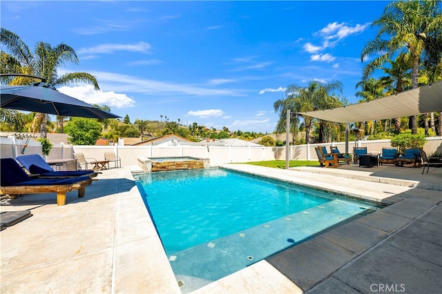 view of pool featuring a patio area, a fenced backyard, and a pool with connected hot tub