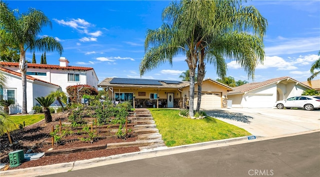 view of front of property with solar panels, a garage, a front yard, concrete driveway, and stucco siding