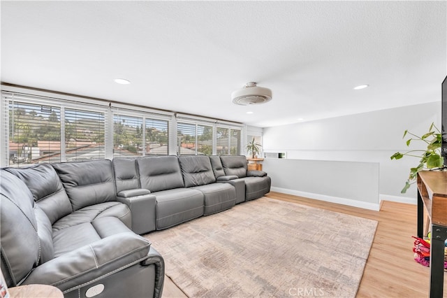 living room with baseboards, light wood-style flooring, and recessed lighting