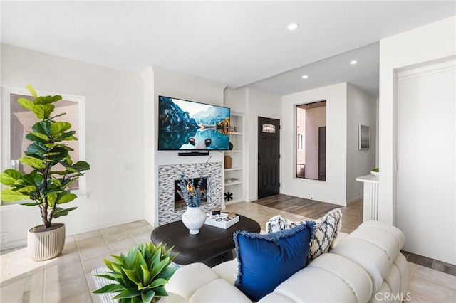3012 W Oceanfront, Newport Beach, CA 92663 - living area with recessed lighting, built in shelves, light tile patterned flooring, a fireplace, and baseboards