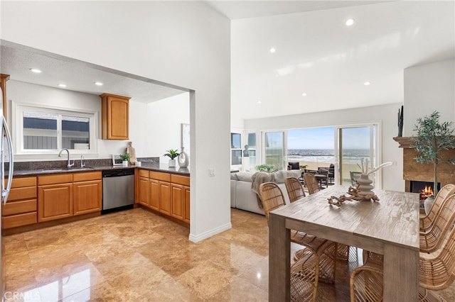 3012 W Oceanfront, Newport Beach, CA 92663 - kitchen featuring dishwasher, a sink, a towering ceiling, dark countertops, and recessed lighting