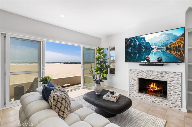 3012 W Oceanfront, Newport Beach, CA 92663 - living room featuring a fireplace, light tile patterned floors, recessed lighting, and baseboards