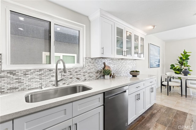3012 W Oceanfront, Newport Beach, CA 92663 - kitchen with stainless steel dishwasher, a sink, backsplash, and white cabinets