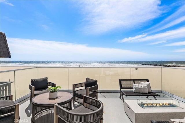 3012 W Oceanfront, Newport Beach, CA 92663 - view of patio with a fire pit and view of water and beach
