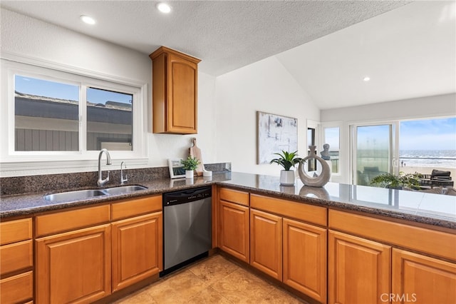 3012 W Oceanfront, Newport Beach, CA 92663 - kitchen with dishwasher, a sink, vaulted ceiling, dark stone counters, and brown cabinets