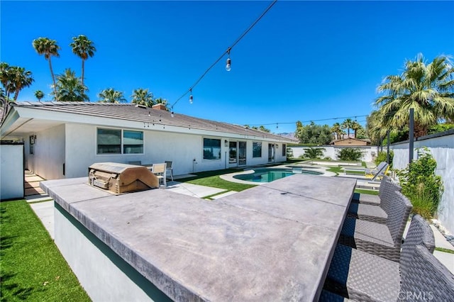 76010 Fairway Dr, Indian Wells, CA 92210 - rear view of property with a fenced in pool, a patio area, stucco siding, and a fenced backyard