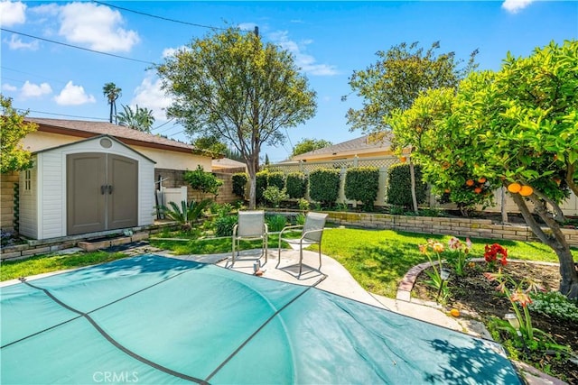 view of pool with a shed, a fenced backyard, a patio area, and an outdoor structure