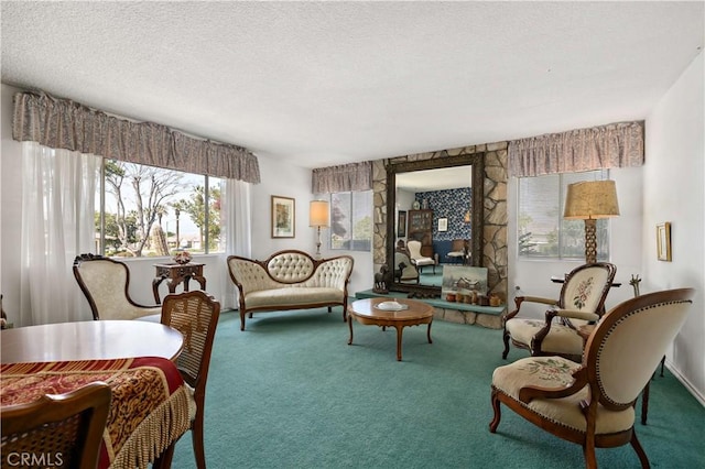 living area featuring carpet floors, baseboards, plenty of natural light, and a textured ceiling