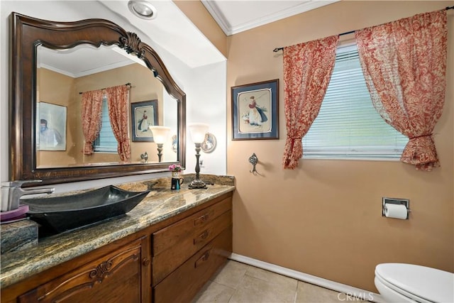 half bath featuring vanity, baseboards, tile patterned flooring, crown molding, and toilet