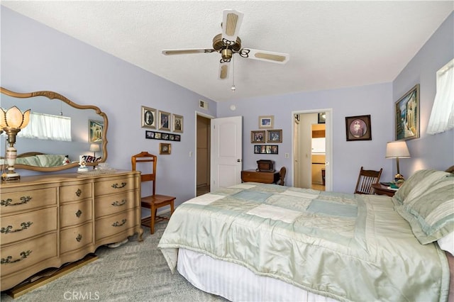 bedroom featuring ceiling fan, connected bathroom, and carpet floors