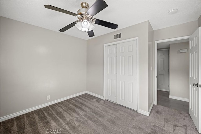 unfurnished bedroom with visible vents, baseboards, a closet, and carpet