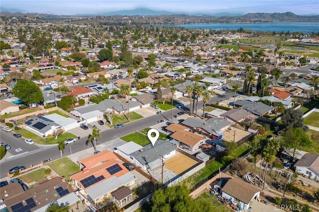 drone / aerial view with a water and mountain view and a residential view